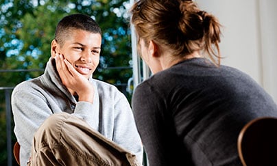 Counselor with teen boy